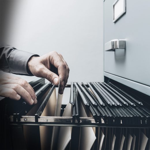 Man organizing filing cabinet